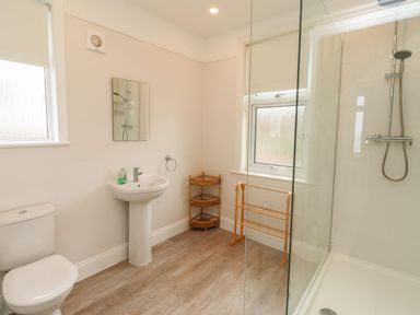 A bathroom with a sink and shower at Glen Avon in Seahouses