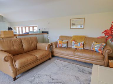 A living room with two leather sofas and a coffee table at The Granary Wyke Nr Axminster
