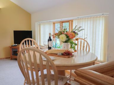 A dining room with a table set with food and drink at The Granary in Wyke Nr Axminster