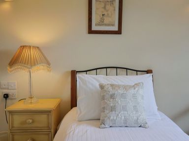 A bedroom with a bed and bedside table at The Granary in Wyke Nr Axminster