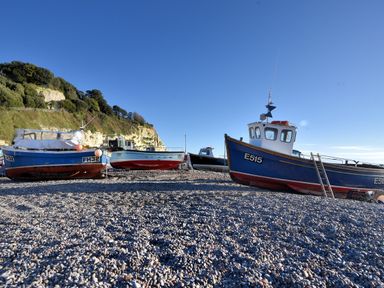 Three boats on a pebble beach at The Granary Wyke Nr Axminster