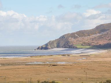 A coastal landscape featuring a beach and cliffs at Woodedge in Minehead