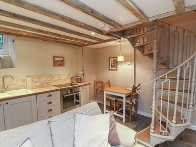 A kitchen with a sink and stove at Woodedge in Porlock