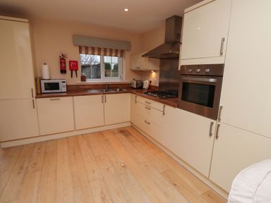 A kitchen with cabinets and appliances at High Sea View