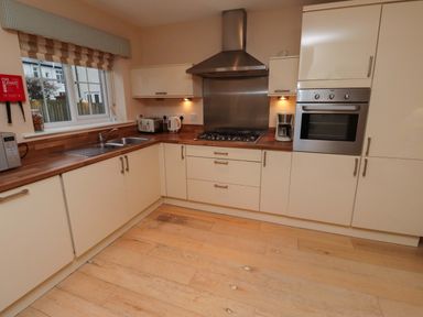 A kitchen with a sink and stove at High Sea View