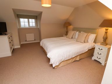 A bedroom with a bed and television at High Sea View