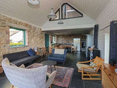 A living room with a sofa and coffee table at The Barn in Newport