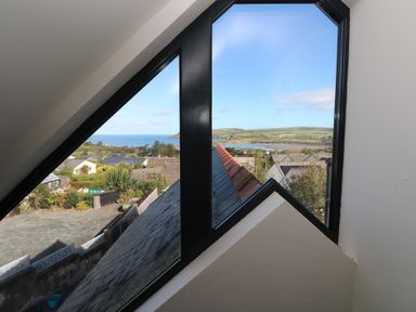 A view of rooftops and landscape from a window in the loft at The Barn in Newport
