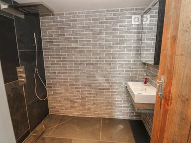 A bathroom with a shower and sink at The Barn in Newport
