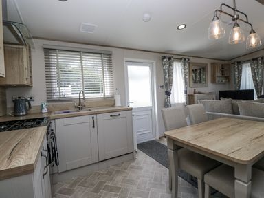 A kitchen with dining area and appliances at Grasmoor View Lodge