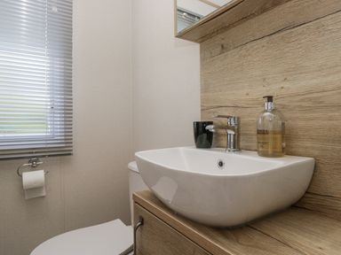 A bathroom with a sink and toilet at Grasmoor View Lodge