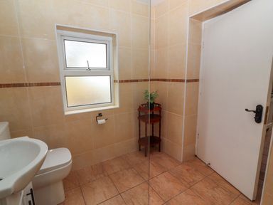 A bathroom with a sink and toilet at The Farmhouse in Tralee, County Kerry
