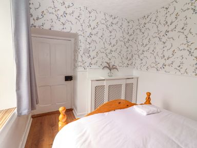 A bedroom with a bed and door at The Farmhouse in Tralee, County Kerry