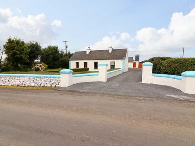 A house with a driveway and fence at The Farmhouse in Tralee, County Kerry
