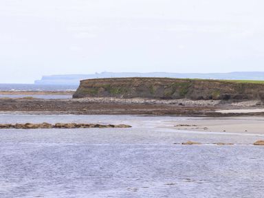 A coastal landscape with a cliff and water at The Farmhouse in Tralee, County Kerry