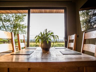 A dining room with a table and chairs at The Red House in Farndon