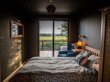 A bedroom with a bed and armchair at The Red House in Farndon