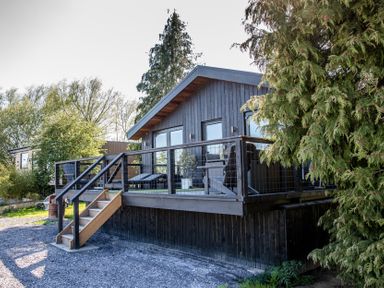 A house with a deck and stairs at The Larch House in Farndon