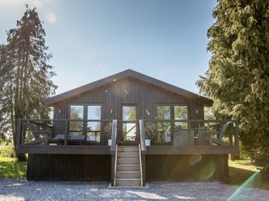 A house with a balcony and steps at The Larch House in Farndon