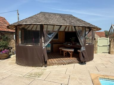 A gazebo with seating area at Granary Cottage in Lacock