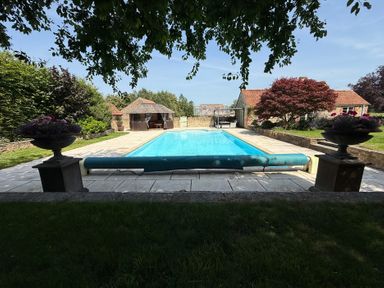 An outdoor area with a swimming pool at Granary Cottage in Lacock