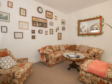 A living room with a sofa and armchair at Apartment 1 The Bridge at Stanford Hotel near Great Witley