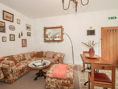A living room with a sofa and coffee table at Apartment 1 The Bridge at Stanford Hotel near Great Witley
