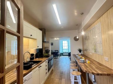 A kitchen with cabinets and countertop at Llanrwst Apartment
