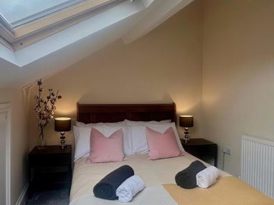 A bedroom with a bed and bedside tables at Llanrwst Apartment
