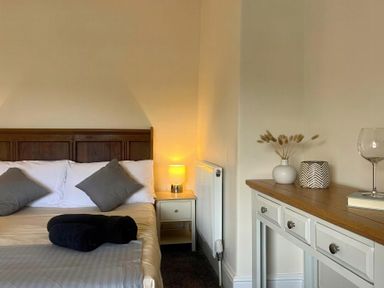 A bedroom with a bed and nightstand at Llanrwst Apartment