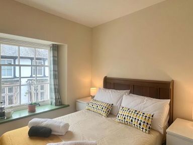 A bedroom with a bed and window at Llanrwst Apartment 