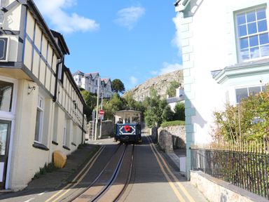 A street with a trolley and buildings at Mariners Lee in Llandudno