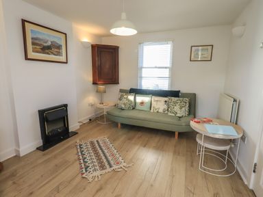 A living room with a sofa and coffee table at Swirl Howe in Keswick