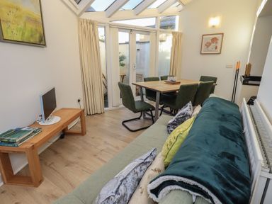 A dining room with a table and chairs at Swirl Howe in Keswick