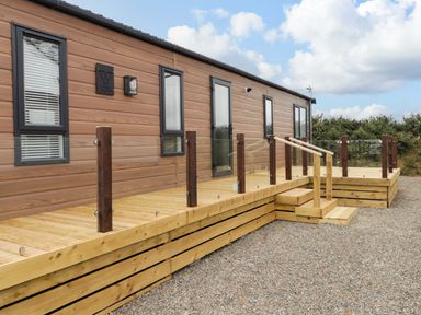 A building with a wooden deck and steps at Dolphin in Haverfordwest