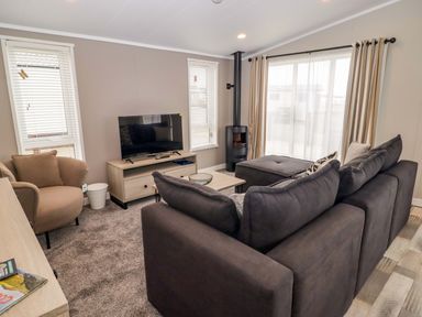 A living room with a sofa and television at Dolphin in Haverfordwest