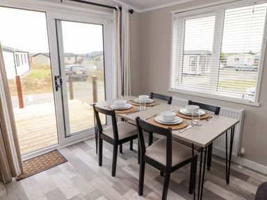 A dining room with a table set for meals at Dolphin in Haverfordwest