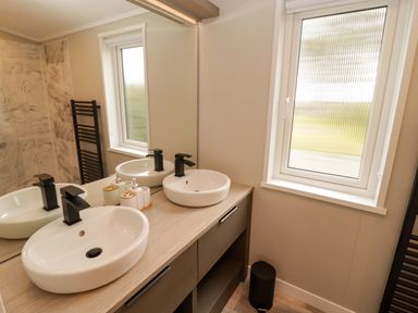 A bathroom with a double sink and mirror at Dolphin in Haverfordwest