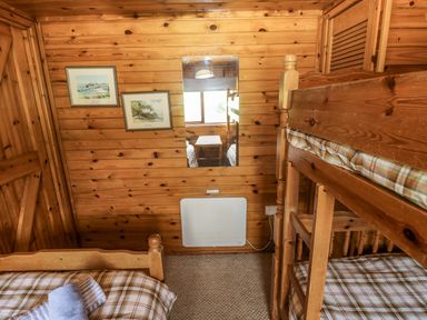 A bedroom with a bunk bed and twin bed at Oak Lodge Mynydd Cerrig near Porthyrhyd