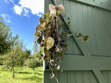 A hanging decoration with dried flowers on a green door at West Cottage Myddfai near Llandovery