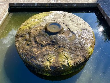 A stone fountain in water at West Cottage Myddfai near Llandovery