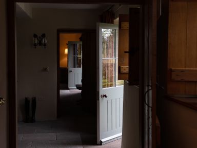 A hallway with doors and windows at West Cottage in Myddfai near Llandovery