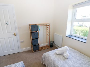 A bedroom with storage and a bed at Hawthorns in Swansea