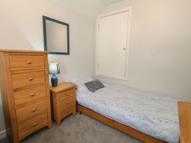 A bedroom with a bed and furniture at June Cottage in Wool