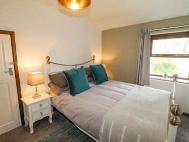 A bedroom with a bed and a bedside table at Clawddcam in Mathry