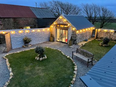 An outdoor area with stone building and garden at Clawddcam in Mathry