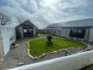 A garden with gravel and grass at Clawddcam in Mathry