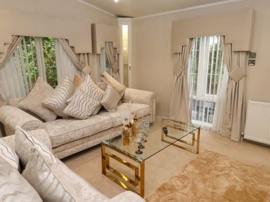 A living room with a sofa and coffee table at The Chalet at Tyn Lon in Chwilog