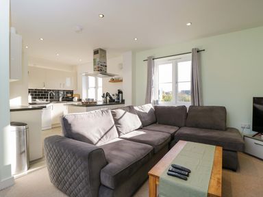 A living room with a couch and coffee table at Swallows Nest in Bourton-On-The-Water