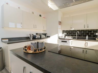 A kitchen with cabinets and appliances at Swallows Nest Bourton-On-The-Water
